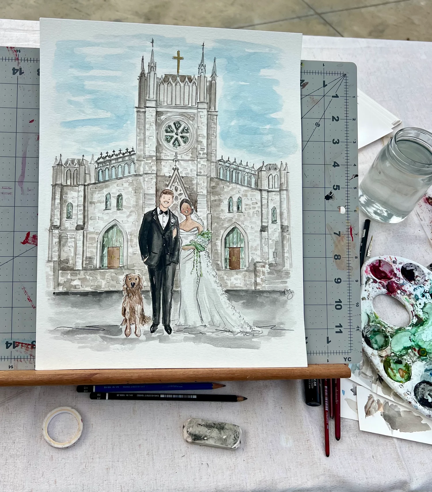 Carmen’s watercolor painting of a bride and groom with their dog in front of a church