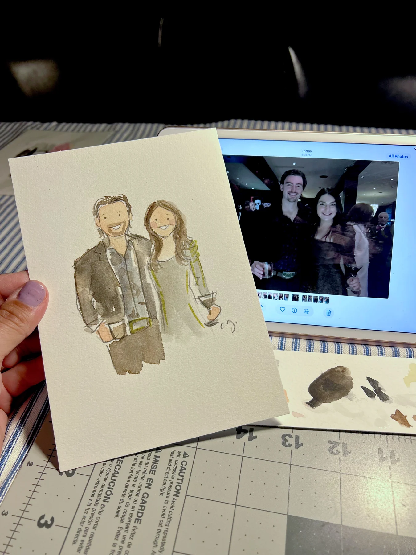 A watercolor couple portrait beside its photographic reference